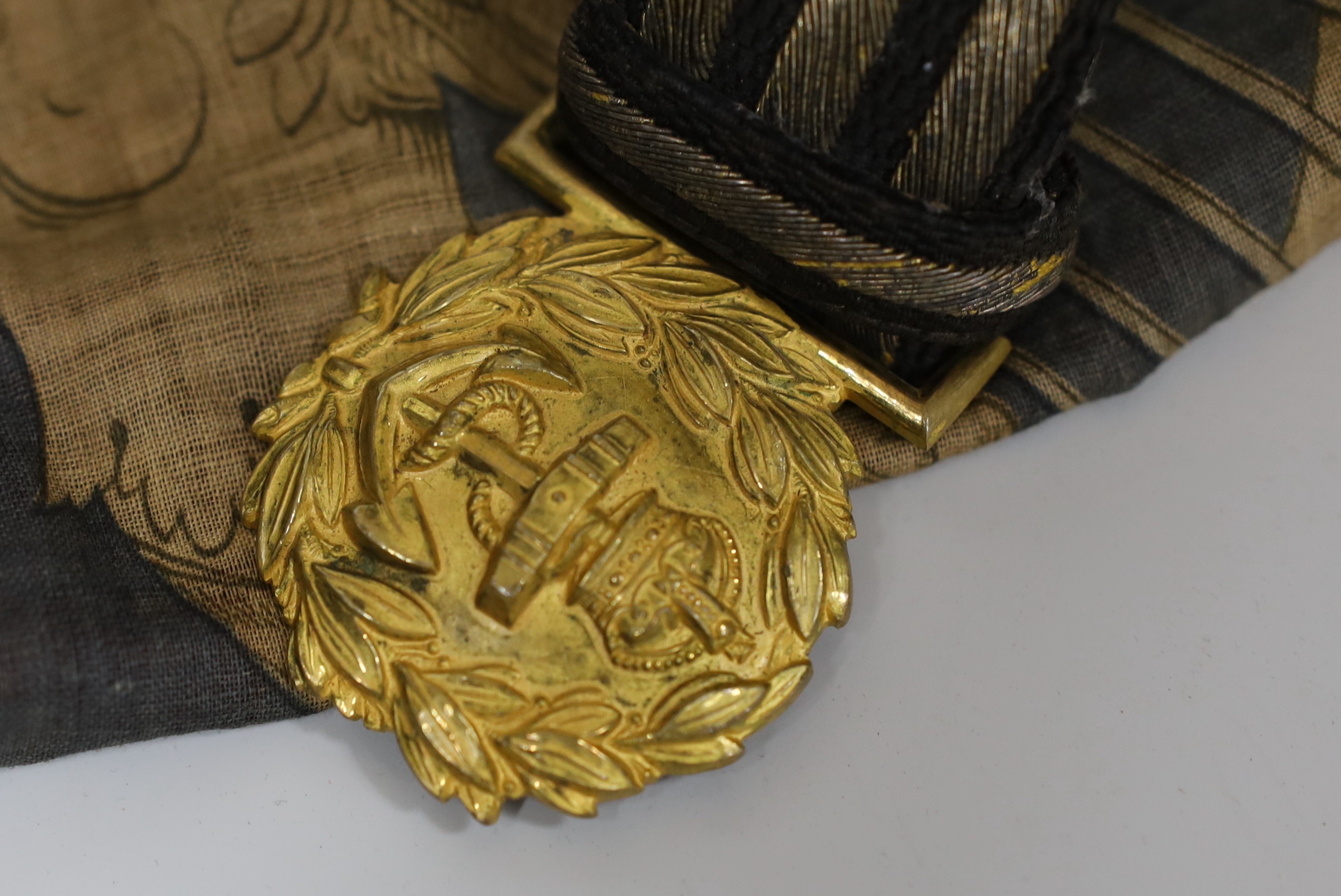 A Royal Naval gilt brass mounted officers belt, an Edwardian Dieu et mon droit belt, a Victorian printed flag and A Victorian Yorkshire Regiment officers brocade sword belt